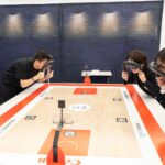 Participants watching Canon remote Asian Games basketball volumetric MR demo