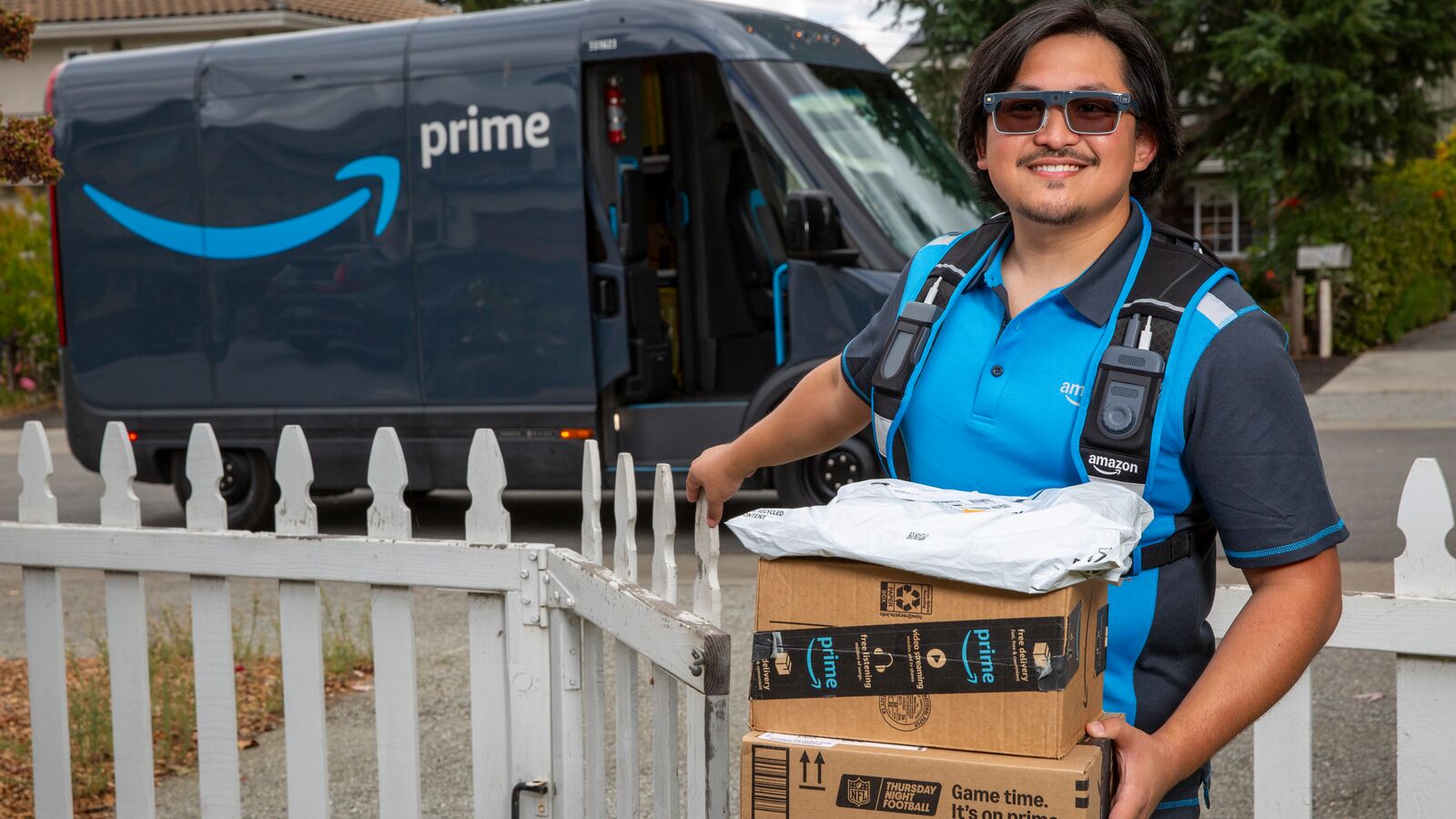 Amazon driver with Smart Delivery Glasses handling packages