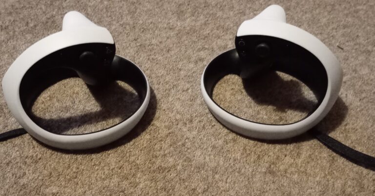 PlayStation VR2 Sense controllers on a dark surface