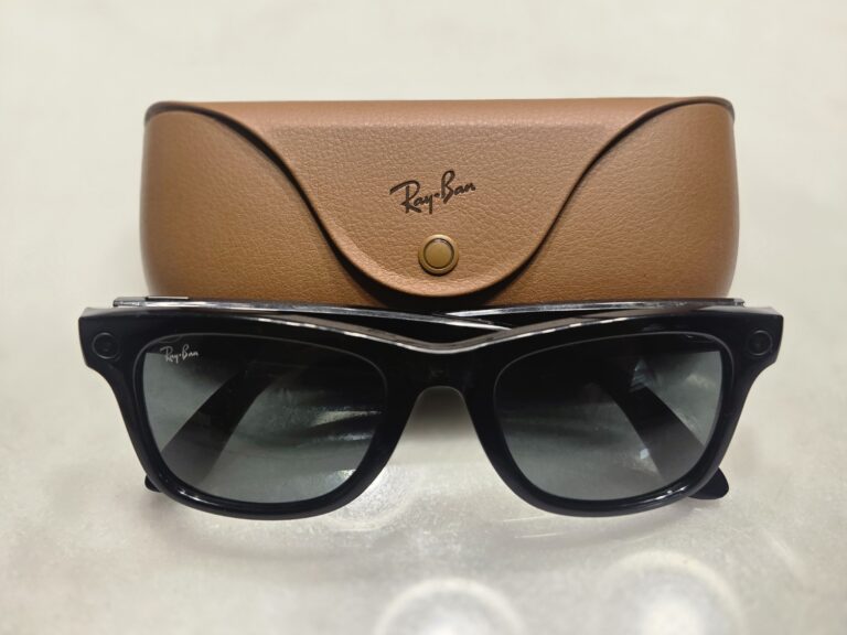Ray-Ban Meta smart glasses with charging case on a desk