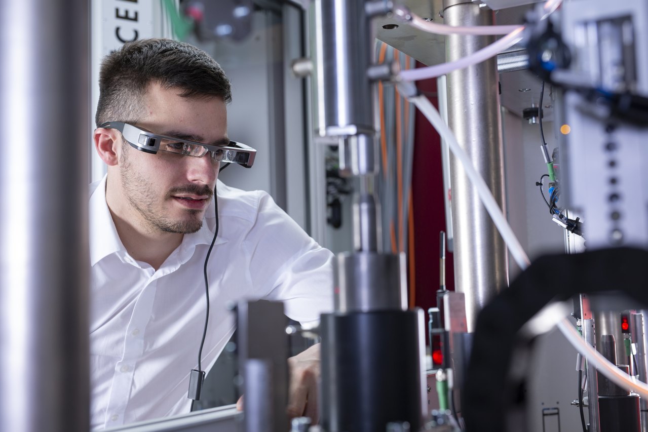 Technician using augmented reality overlays during industrial equipment service