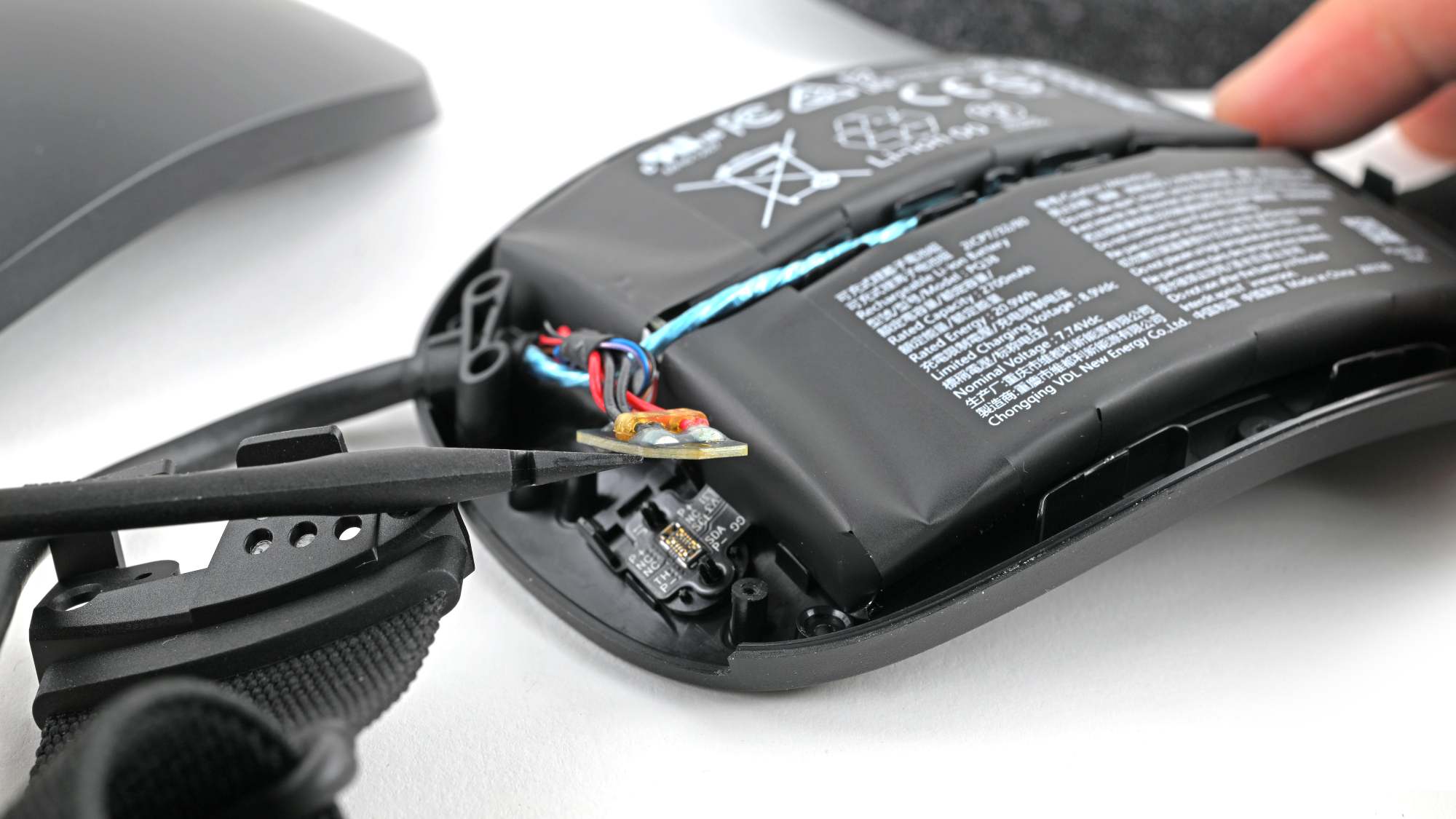 Steam Frame curved two-cell 20.9 Wh LiPo battery in headband during teardown