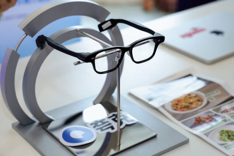 Alibaba Quark AI glasses on a product display stand