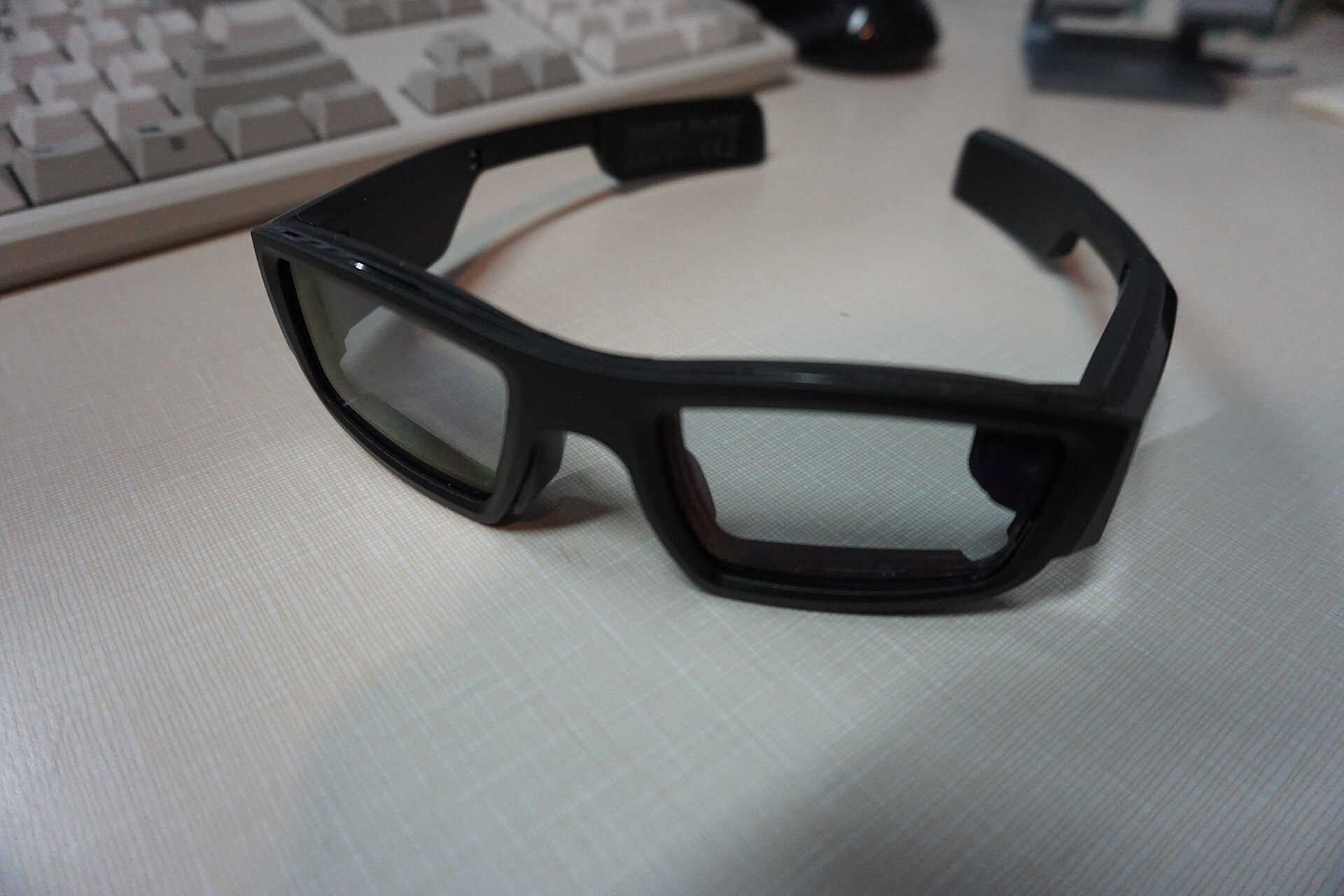 Close-up of smart glasses temples on a desk — the left temple is the part CPSC flags on INMO Air3