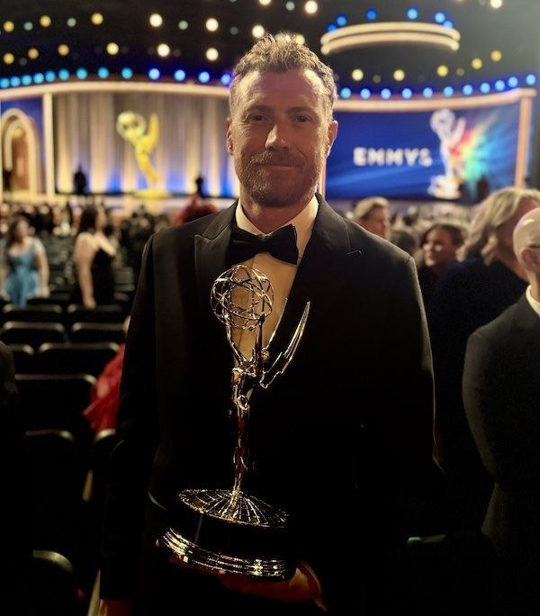 Rick Treweek holding the Outstanding Emerging Media Program Emmy