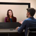 Google Beam light-field display showing a life-size remote participant across a table — official Google press image