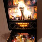 Physical Williams The Addams Family pinball machine with lit backglass and playfield