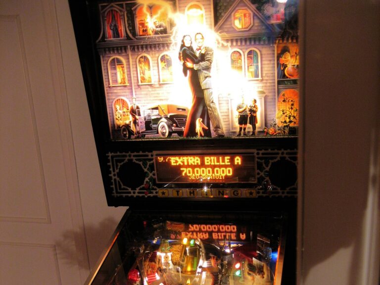 Physical Williams The Addams Family pinball machine with lit backglass and playfield