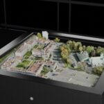 Avalon Holographics NOVAC glasses-free holographic table display showing a 3D city model