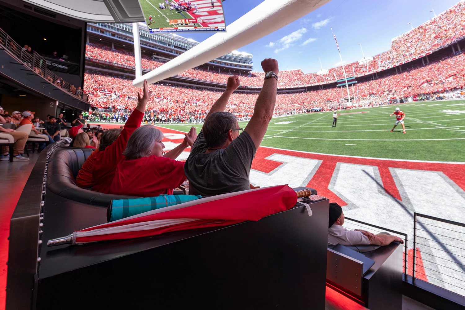 Fans react inside the LED dome at Cosm Dallas during a college football broadcast