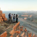 Visitors in VR headsets stand on a virtual Great Pyramid ledge in Excurio Horizon of Khufu, an LBXR Pulse expedition