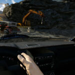 FlatOut 4: Total Insanity VR cockpit view with the player's hand on the wheel as a rusty hot rod skids across a quarry track