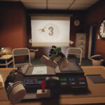 Good Morning [Employee Name] VR screenshot: a desk station with a training-film countdown on a projector screen and a cardboard-cutout coworker