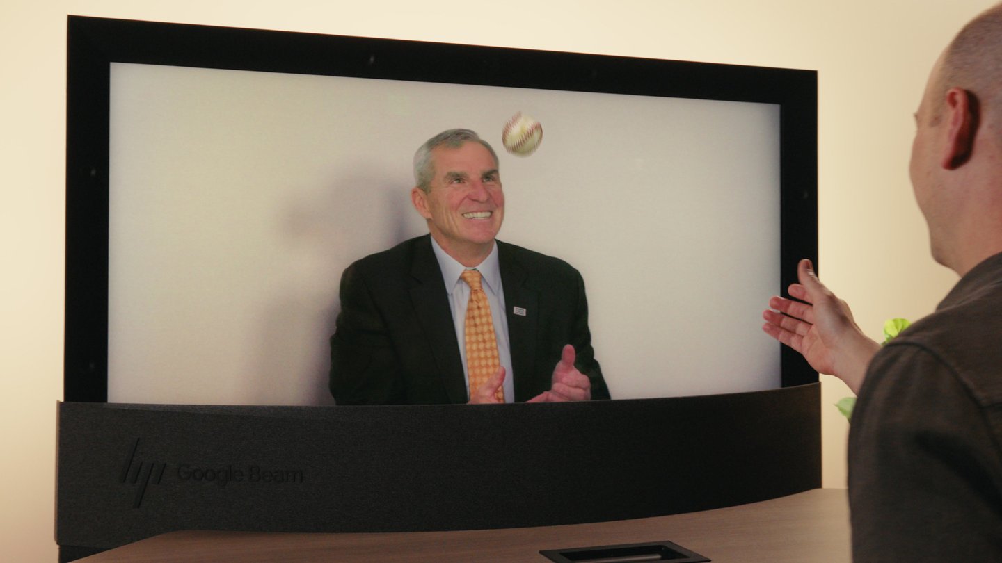 HP Dimension with Google Beam display showing a life-size 3D video call participant across a table