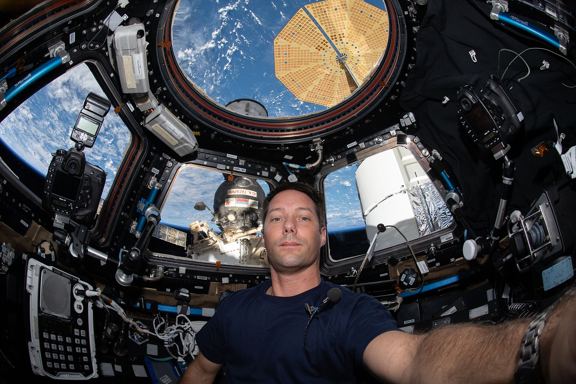Thomas Pesquet inside the ISS cupola looking at Earth