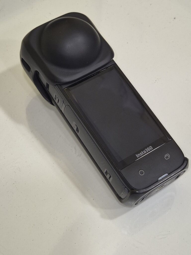 Insta360 X4 360-degree camera on a white surface
