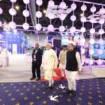 Visitors walking through the Jio pavilion at India Mobile Congress 2022 in New Delhi, with a large illuminated Jio logo