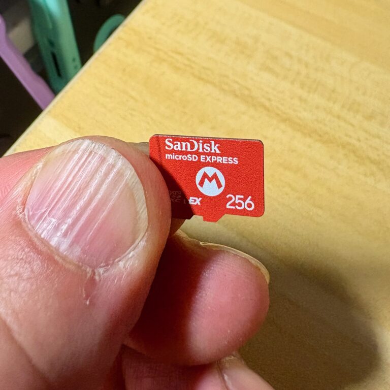A SanDisk microSD Express 256GB card held between thumb and finger (Wikimedia Commons, Kyu3a, CC BY-SA 4.0)