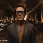Robert Downey Jr. wearing Snap SPECS augmented reality glasses in a dim workshop, from Snap's October 20, 2026 announcement