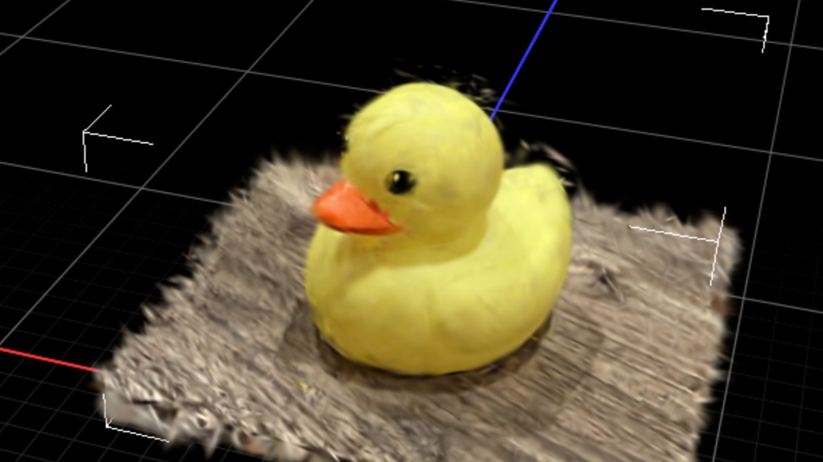 Gaussian splat of a rubber duck on a fuzzy mat, reconstructed by splatting-rs from six phone photos