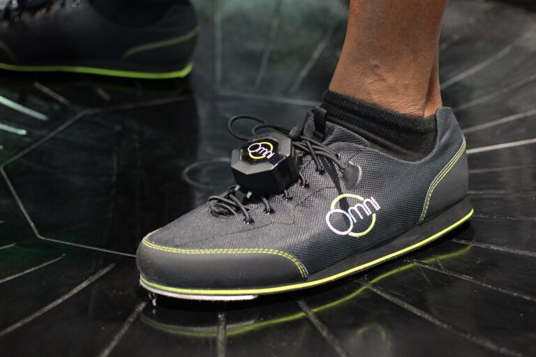 Virtuix Omni overshoe with clip-on foot tracker on the low-friction platform, CES 2016