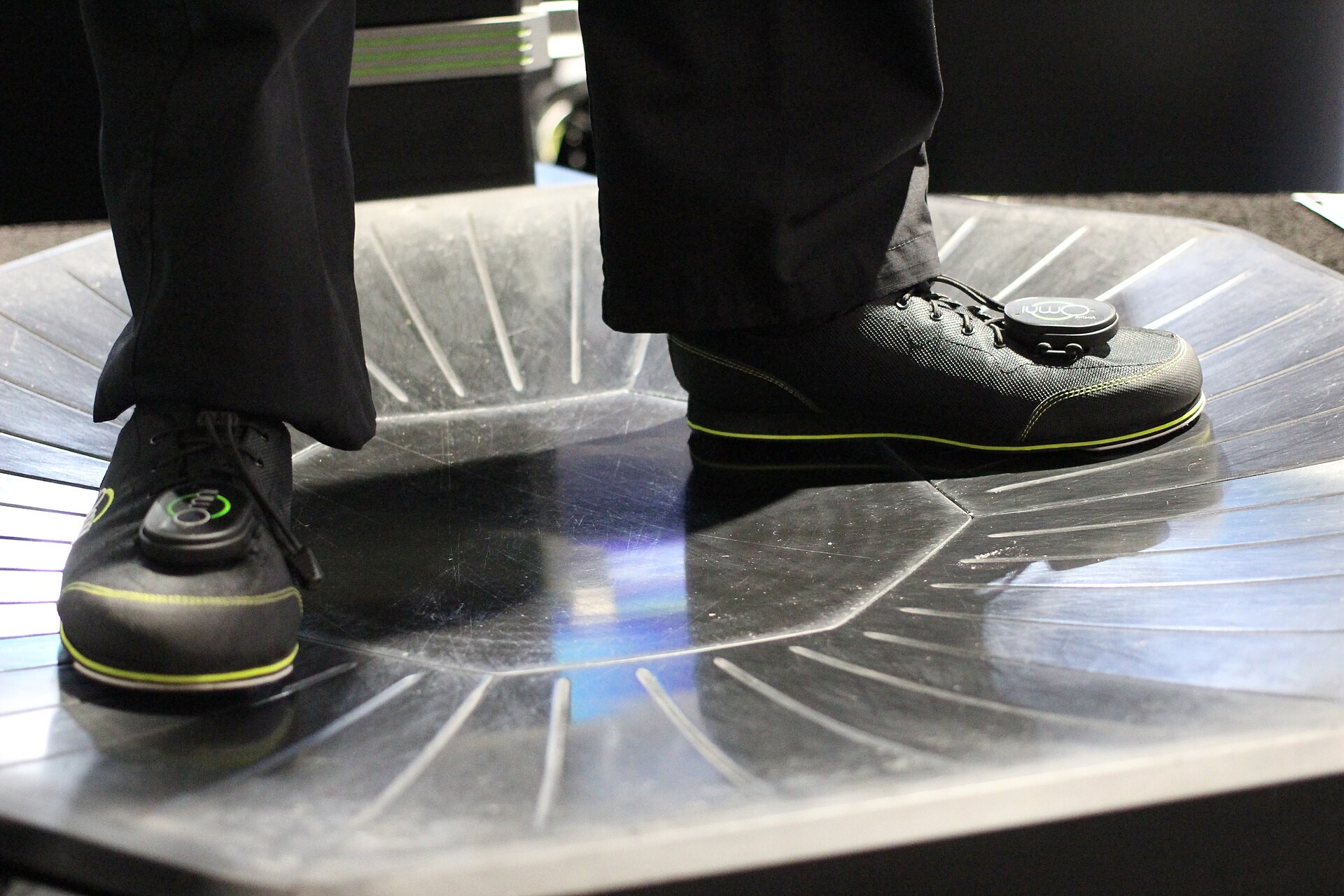 Two Virtuix Omni overshoes with tracking pods on the treadmill platform, CES 2015