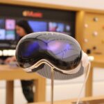 Apple Vision Pro headset with the Solo Knit Band on a display stand inside an Apple Store