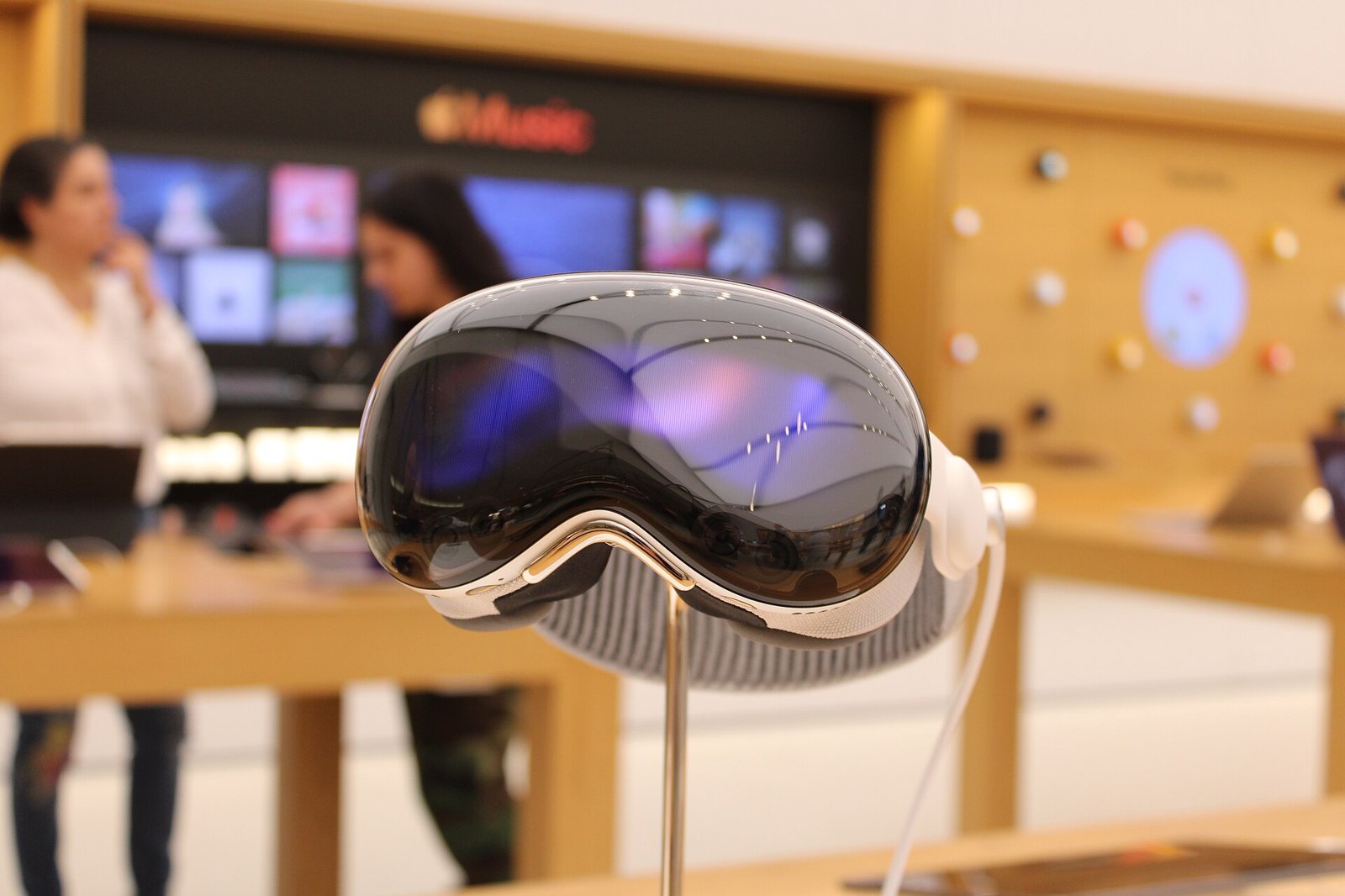 Apple Vision Pro headset with the Solo Knit Band on a display stand inside an Apple Store